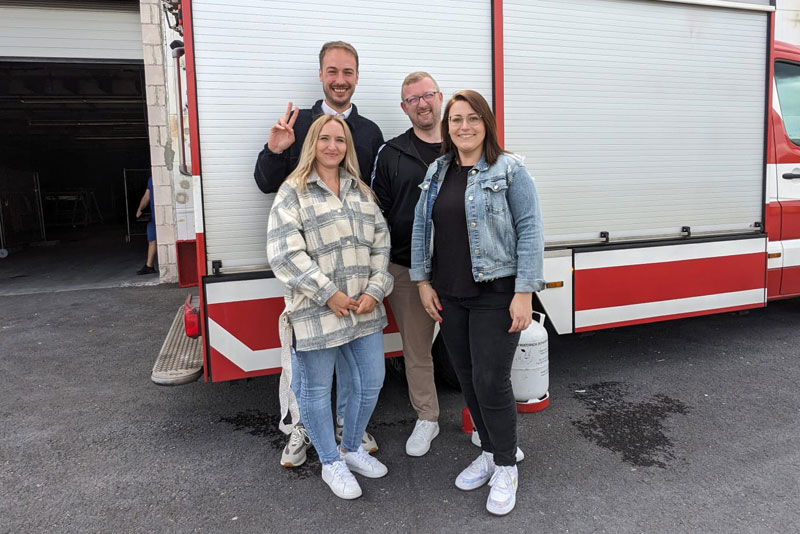 Unser Team vor einem Feuerwehrauto